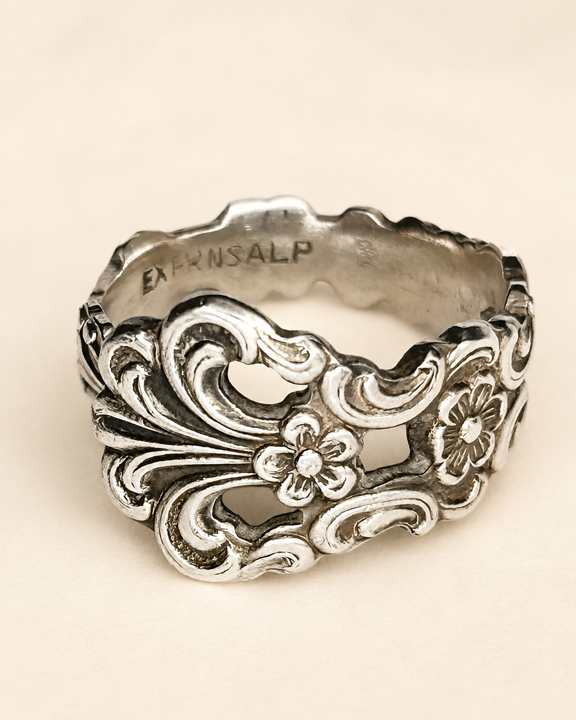 Ornate Alpacca spoon ring with floral scrollwork, front view
